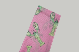 Macro shot of pink mesh knit fabric featuring green lobster print and detailed texture