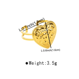 Detailed view of heart-shaped gold ring with hammered texture and 1.8cm diameter