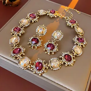 Vintage gold necklace and earring set with red amber stones and crystal pavé details