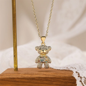 Macro shot of gold teddy bear pendant featuring crystal micro-pave and colorful stones