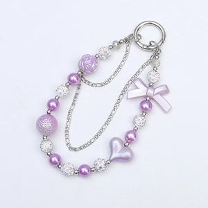 Purple heart and bow phone charm with double chain and beads on a white background