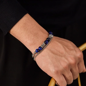 Close-up of double-layer stainless steel bracelet with blue tiger eye stone beads on wrist