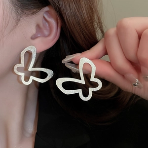 Minimalist silver butterfly cutout stud earrings featuring a stylish matte metal finish