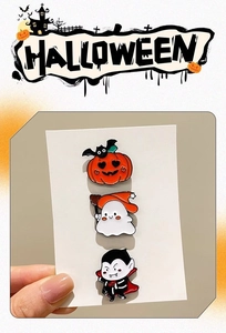 Close-up of Halloween cartoon pins set featuring pumpkin, ghost, and vampire badges