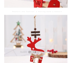 Close-up of red wooden reindeer Christmas ornament with SNOW engraving and star cutouts