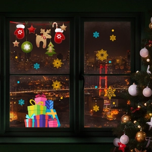Festive Christmas window stickers with snowflakes and reindeer on a warm city night background