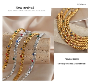Detailed macro view of gold and silver chain bracelets with inlaid colorful gemstones
