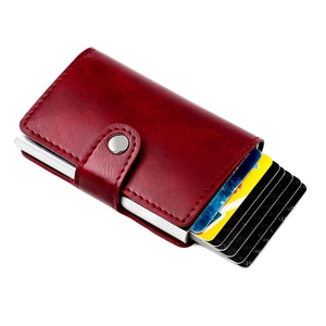 Detail of red leather RFID blocking wallet showing the pop-up card mechanism and metal slot