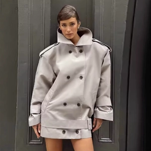 Women's light grey oversized double-breasted trench coat with wide lapels and belt