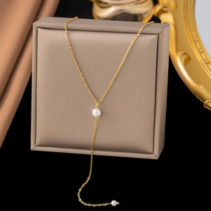 Elegant gold-plated Y-shaped stainless steel necklace with dual white pearls on a display box