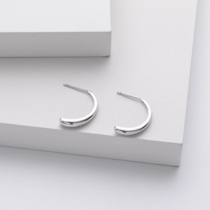 Detailed macro view of S925 sterling silver petal earrings with a polished curved finish