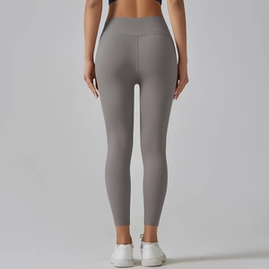 Detail view of high-waisted grey yoga leggings with booty-lifting seam and moisture-wicking fabric