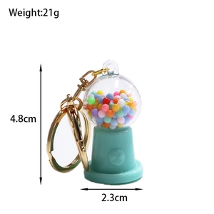Detail shot of mint green candy machine keychain with size dimensions and 21g weight
