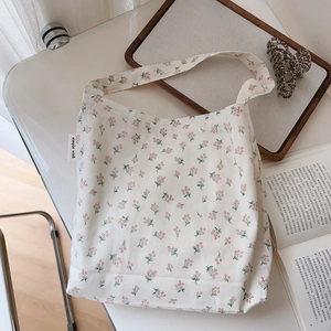 Detailed view of white floral cotton tote with simple wish fabric label and flat base