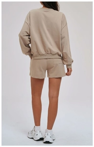 Rear view of oatmeal knit lounge set featuring casual shorts with a practical back pocket