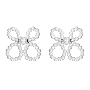 Elegant white pearl flower stud earrings with a bow-shaped design on a plain white background
