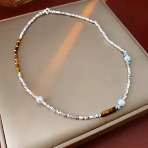 Handmade necklace with silver beads, white pearls, tiger eye stones, and turquoise accents