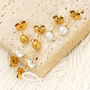 Three pairs of gold titanium steel earrings with pearls, zircons and beads on stone