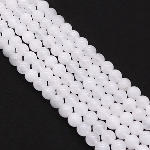Macro view of polished white jade beads showing translucent texture and round shape