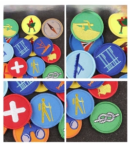 Detail of embroidered outdoor patches showing fine stitching on round scout badges