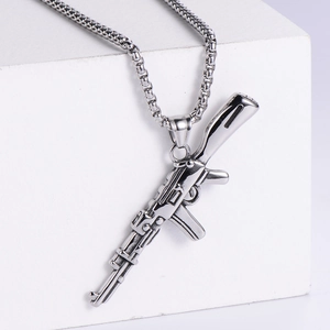 Close-up of polished silver AK-style rifle pendant with detailed metal texture
