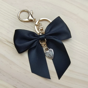 Fashionable black ribbon bow keychain with silver heart charm and gold-tone hardware