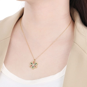 Golden snowflake pendant necklace with colorful rhinestones worn by a fashion model