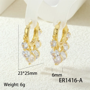 Macro detail of industrial style gold earrings with white zircons and dimensions