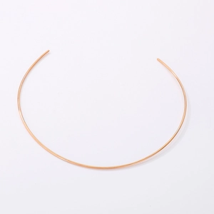 Macro view of rose gold stainless steel open neck collar showing smooth metallic finish