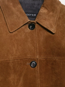 Detailed close-up of brown faux suede jacket collar with high-quality fabric texture