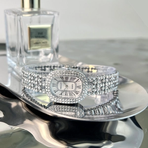 Elegant silver oval quartz watch for women with rhinestone inlay and Roman numerals