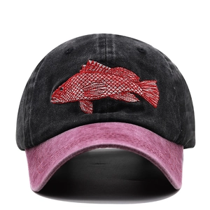 Close-up of vintage washed cotton baseball cap with red fish embroidery and dual-tone colors