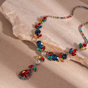 Luxurious multi-color rhinestone necklace set with red teardrop pendant on stone