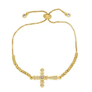 Adjustable gold-plated cross bracelet with sparkling crystals and a sliding bead clasp