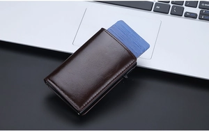 Detail of side-push automatic pop-up card mechanism in brown leather oil wax wallet