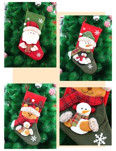 Close-up of festive felt Christmas stockings featuring Santa, Snowman and Reindeer characters