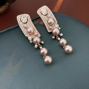 Vintage gold tassel earrings with artificial pearls and shimmering rhinestones