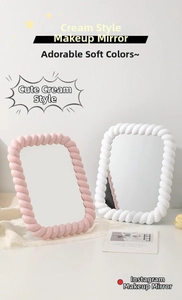Detail of cute cream makeup mirrors with braided frame design in pink and white