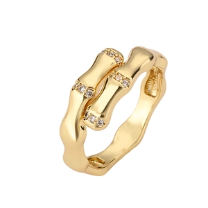 Minimalist gold-plated bamboo link ring with sparkling zircon inlay on white background