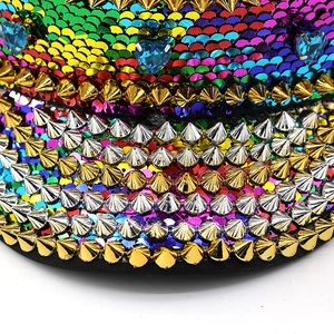 Macro detail of rainbow sequins, metallic studs and blue heart gems on a flat top hat