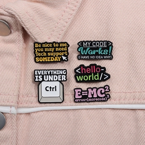 Macro view of geek culture enamel pins with funny coding quotes on a pink denim jacket