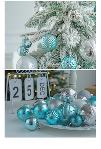 Detailed view of blue and silver Christmas ornaments on a white frosted tree and tray