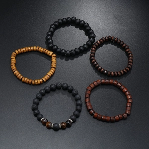 Detail view of handmade multilayer beaded bracelets featuring wood, lava stone and tiger eye