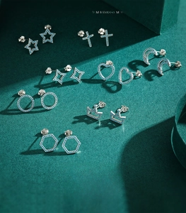 Macro detail of S925 sterling silver studs set with blue turquoise zircon in stars shapes