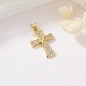 Macro shot of 14K gold plated cross pendant with sparkling clear cubic zirconia stones