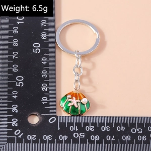 Detail view of pearl seashell keychain weighing 6.5g with starfish and enamel shell