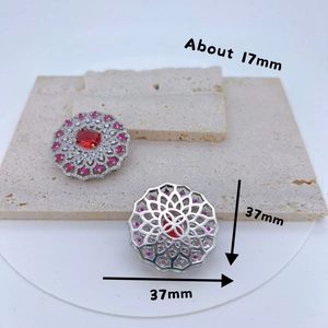 Hollow round silver pendant with red gemstone and white zircon stones on stone base