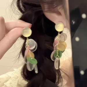 Long dangle earrings with colorful resin discs and silver needles for a casual look