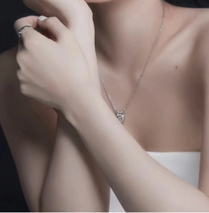 Detail shot of a silver S999 sterling silver necklace with a sparkling number five pendant