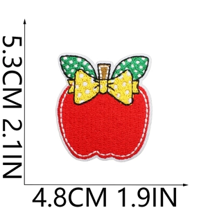 Detailed size view of red apple embroidery patch with yellow bow and green polka dot leaf